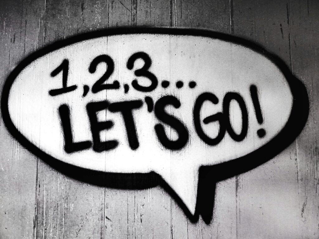 Graffiti-style text saying '1, 2, 3... LET'S GO!' representing QuantumSabre Cybersecurity's launch and readiness to protect businesses.